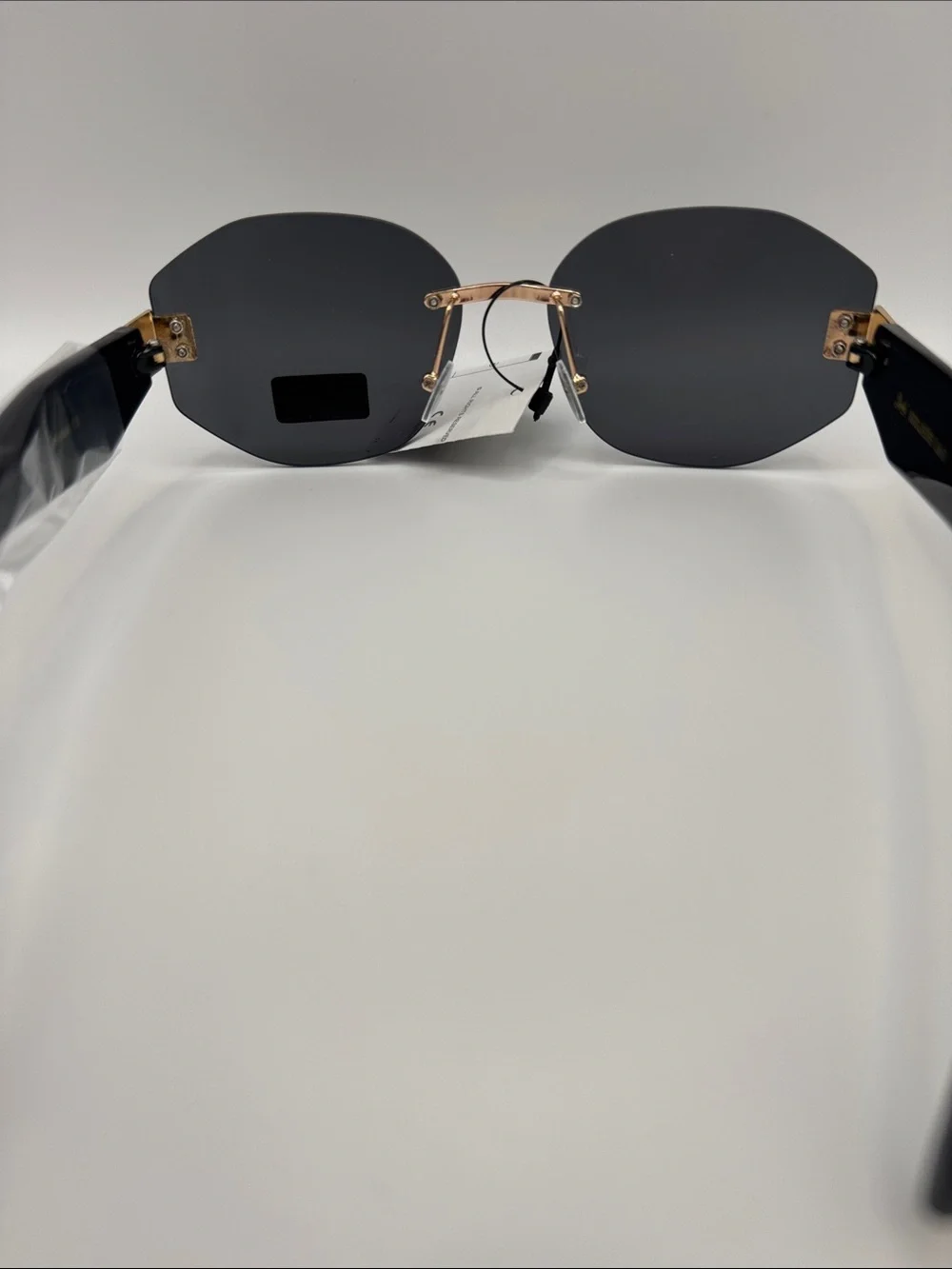 Stylish Black Rimless Women's Sunglasses with Gold Bridge